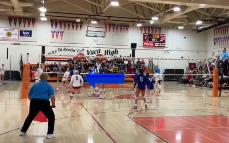 volleyball Recruiting video example. The highlighted player in this video is marked with a blue arrow pointing directly at her from the right.